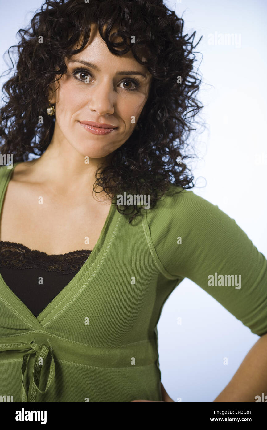 Woman standing and smiling waist up Stock Photo