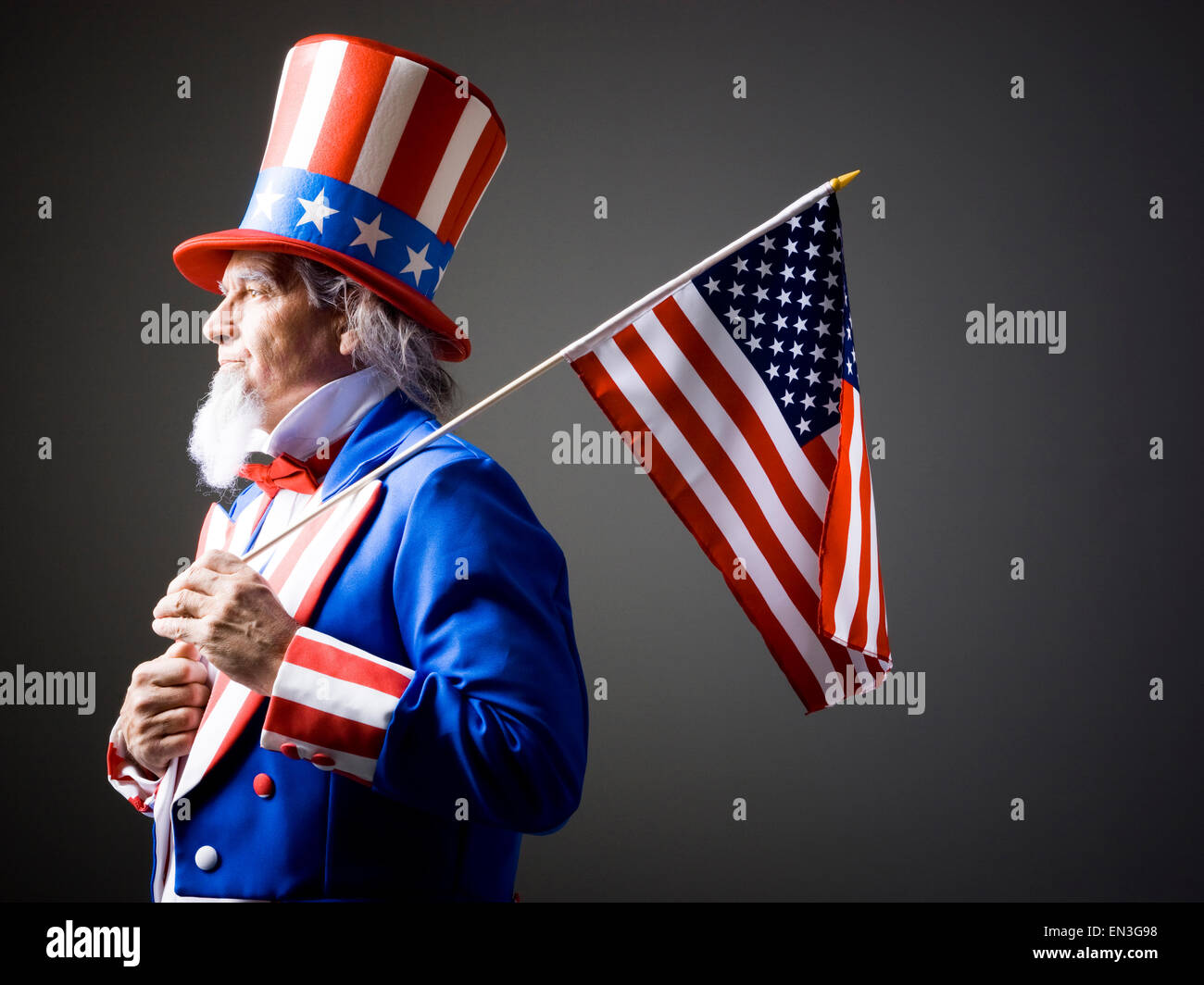 Studio portrait of Uncle Sam with american flag Stock Photo