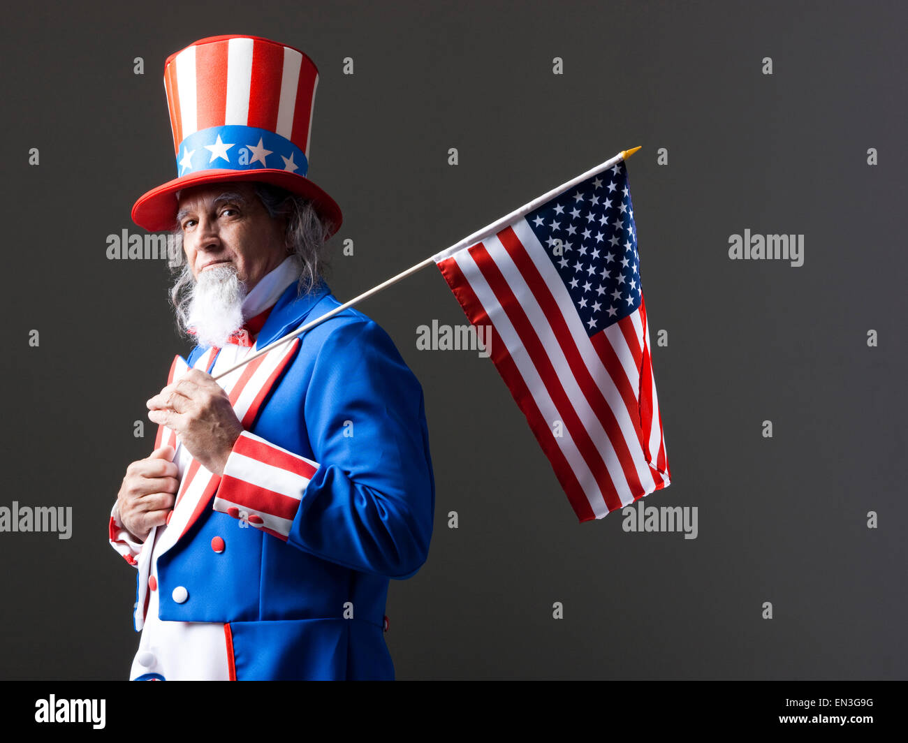 Studio portrait of Uncle Sam with american flag Stock Photo