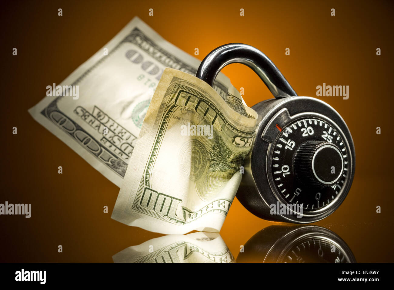 Combination lock with US hundred dollar bill Stock Photo