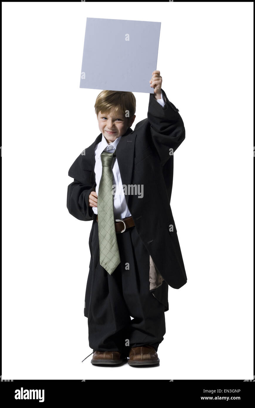 Little boy dressed as business executive with blank sign Stock Photo