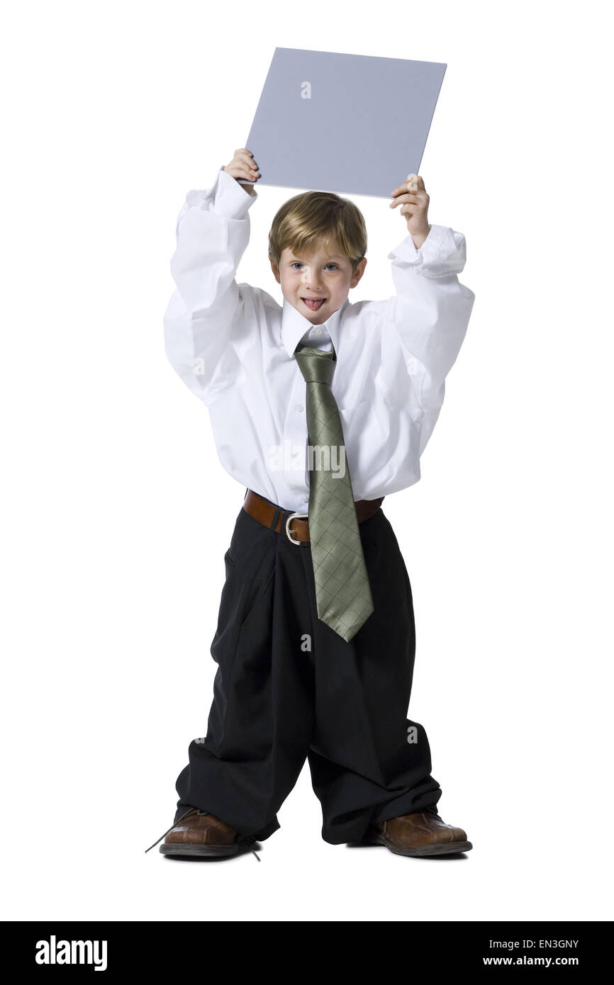 Little boy dressed as business executive with blank sign Stock Photo