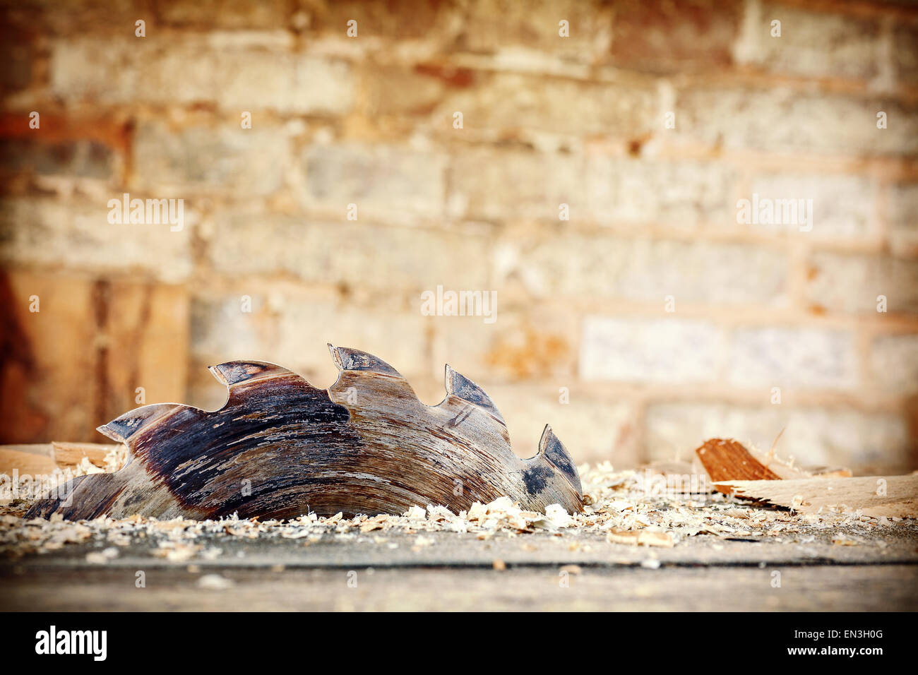 Retro stylized old circular saw in carpenter's shop, space for text. Stock Photo