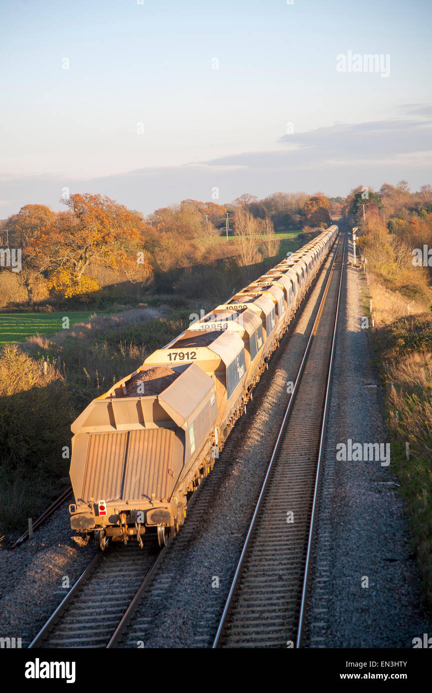 Open wagons of freight train on the West Coast mainline at Woodborough, Wiltshire, England, UK Stock Photo