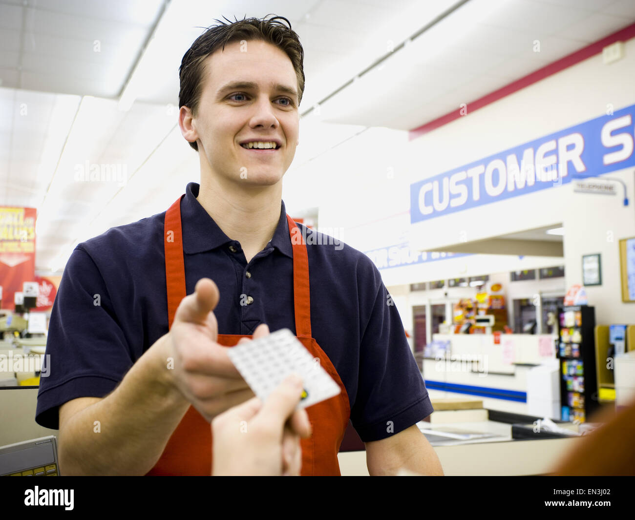 Cashier taking money from customer Stock Photo