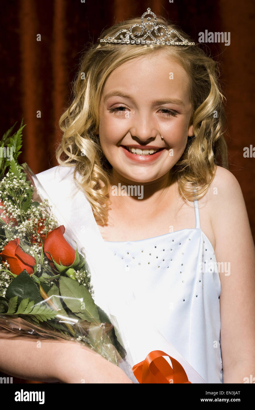 Beauty pageant winner smiling and holding roses Stock Photo