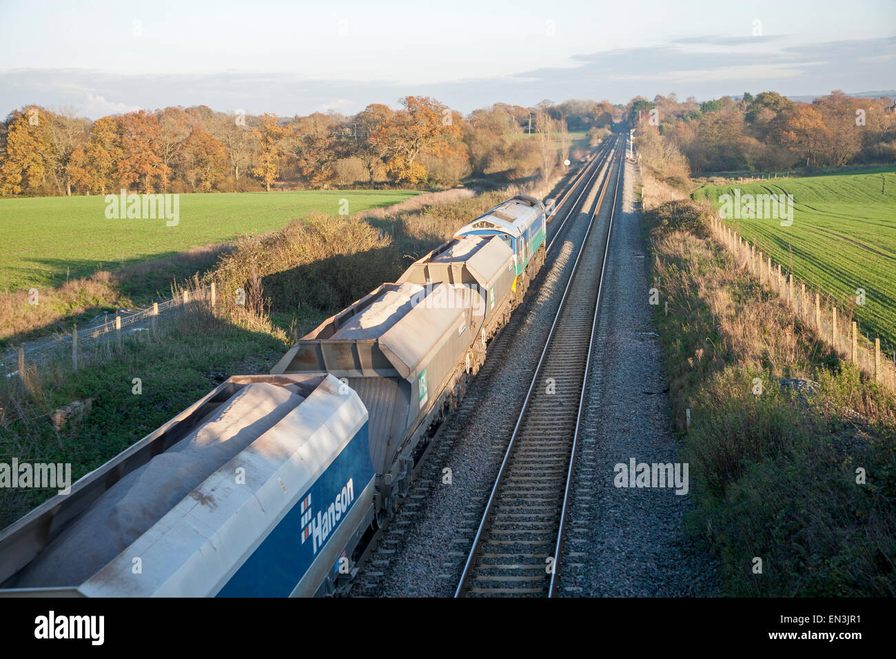 Open wagons of freight train on the West Coast mainline at Woodborough, Wiltshire, England, UK Stock Photo