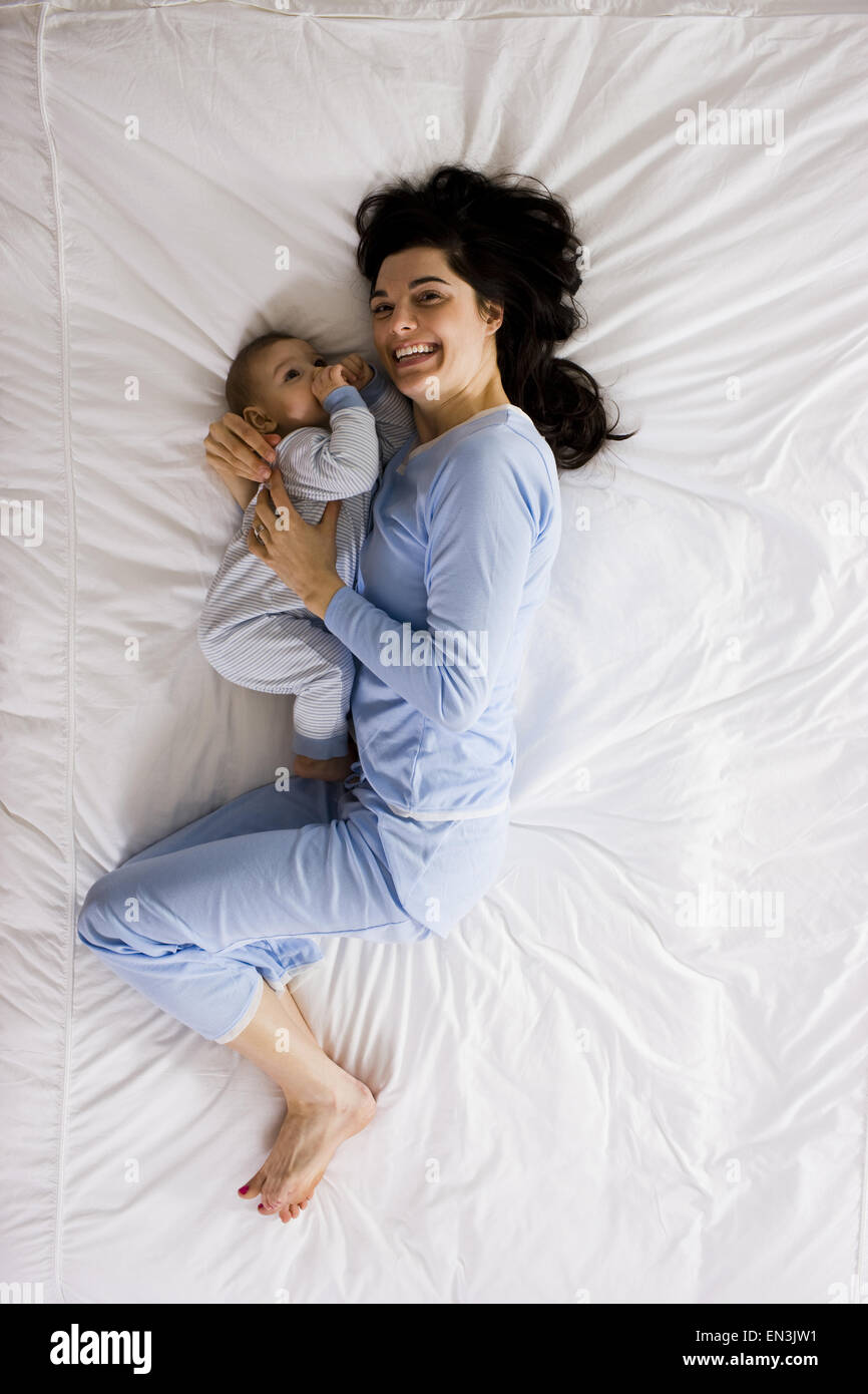 mother and baby in bed Stock Photo