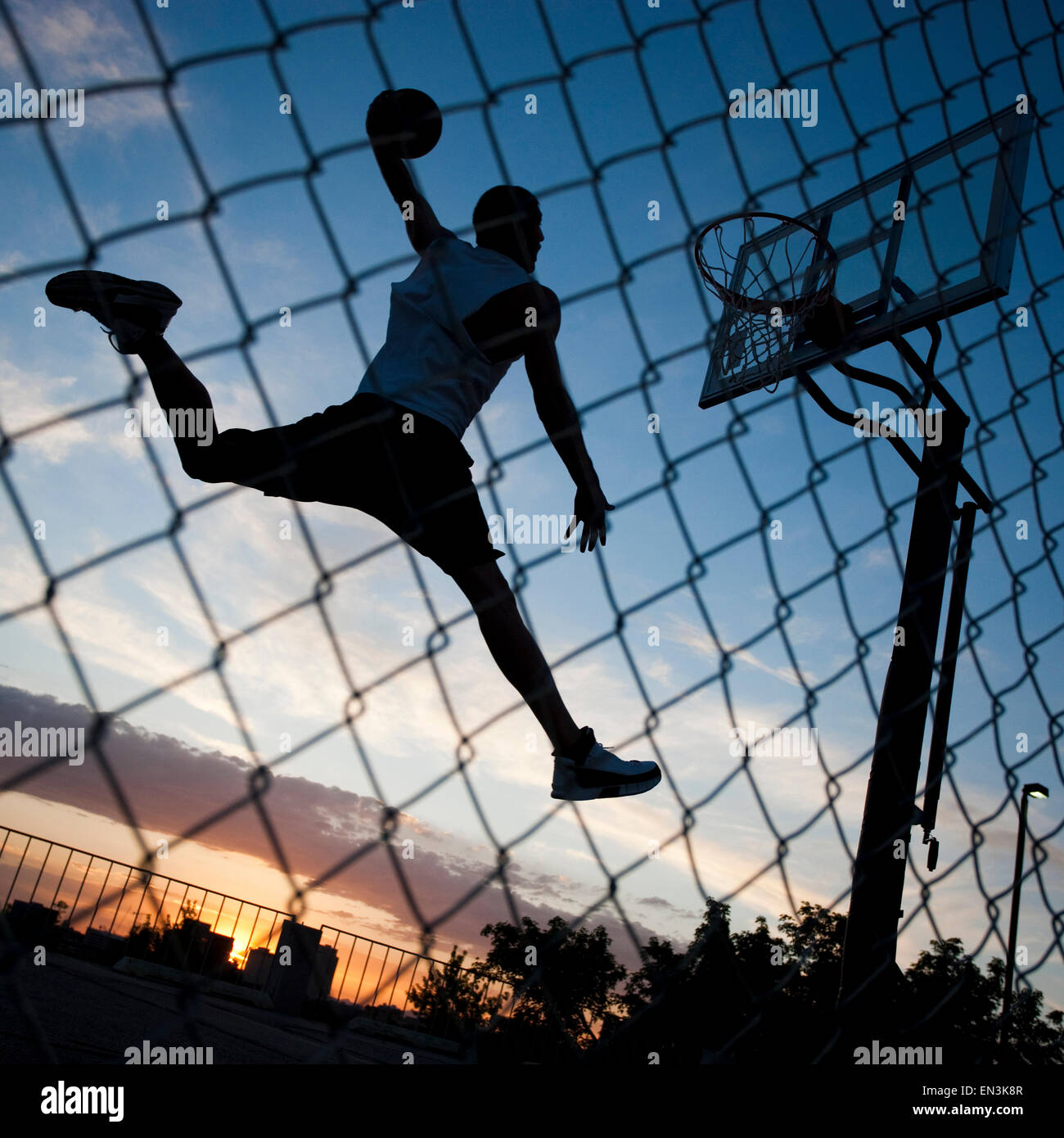 USA,Utah,Salt Lake City,Basketball player slam dunking ball Stock Photo