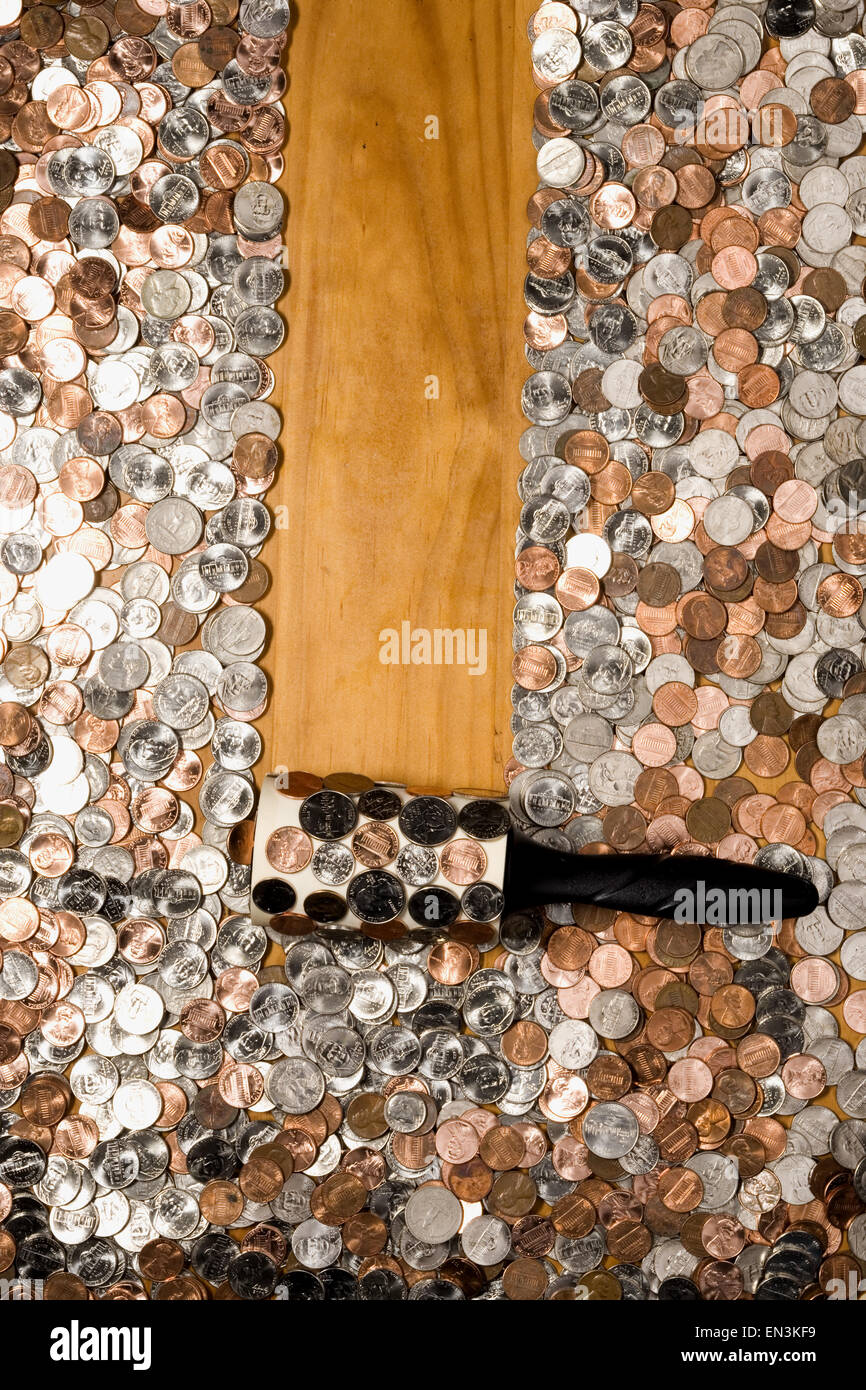 Lint roller picking up loose change Stock Photo