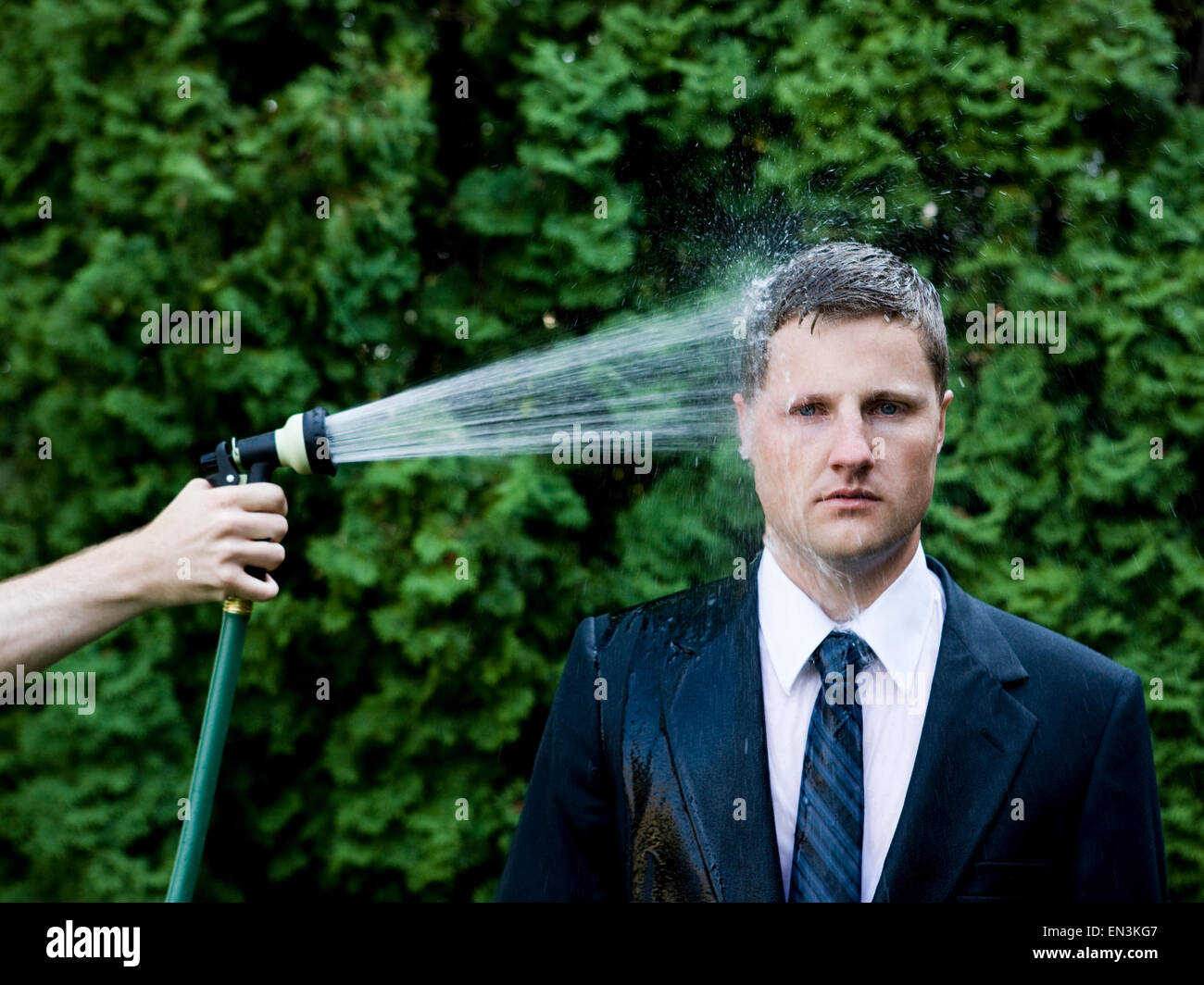 man in a suit and tie getting sprayed in the head with a hose Stock Photo 81830455 Alamy
