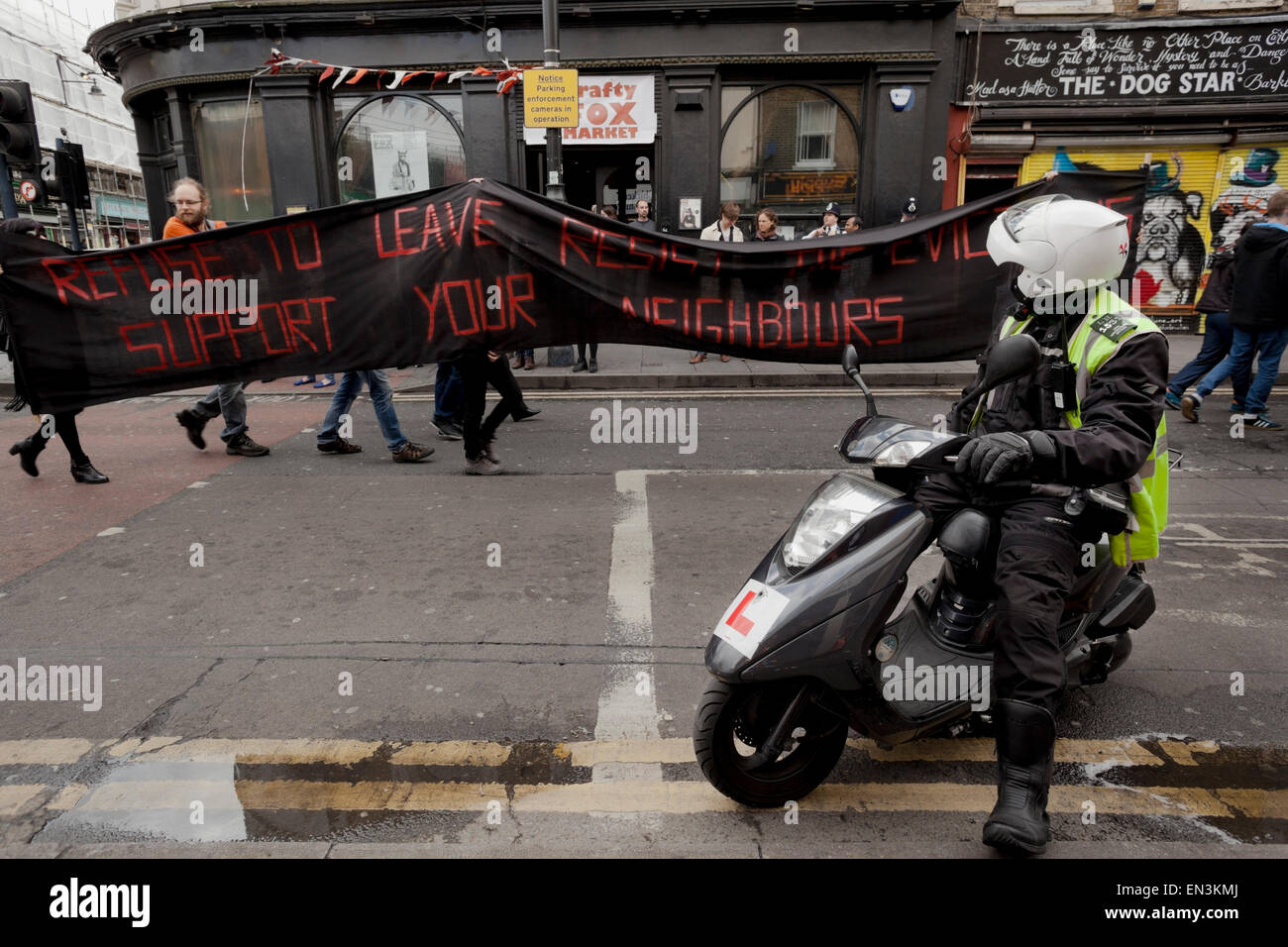A motorcyclist watches the Reclaim Brixton Marchers pass the Dogstar nightclub Stock Photo