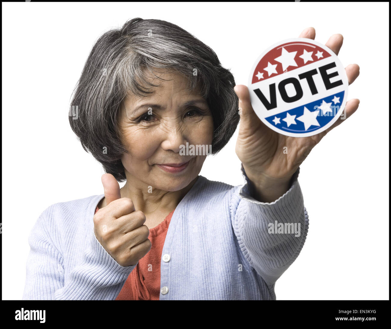woman with a "vote" button Stock Photo