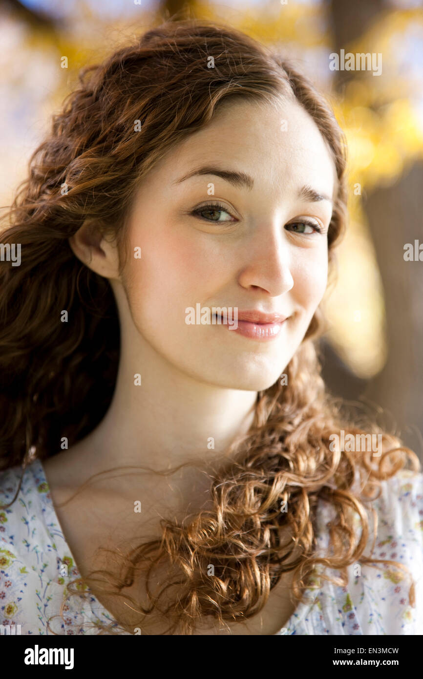 Portrait of young woman standing in Autumn forest Stock Photo - Alamy