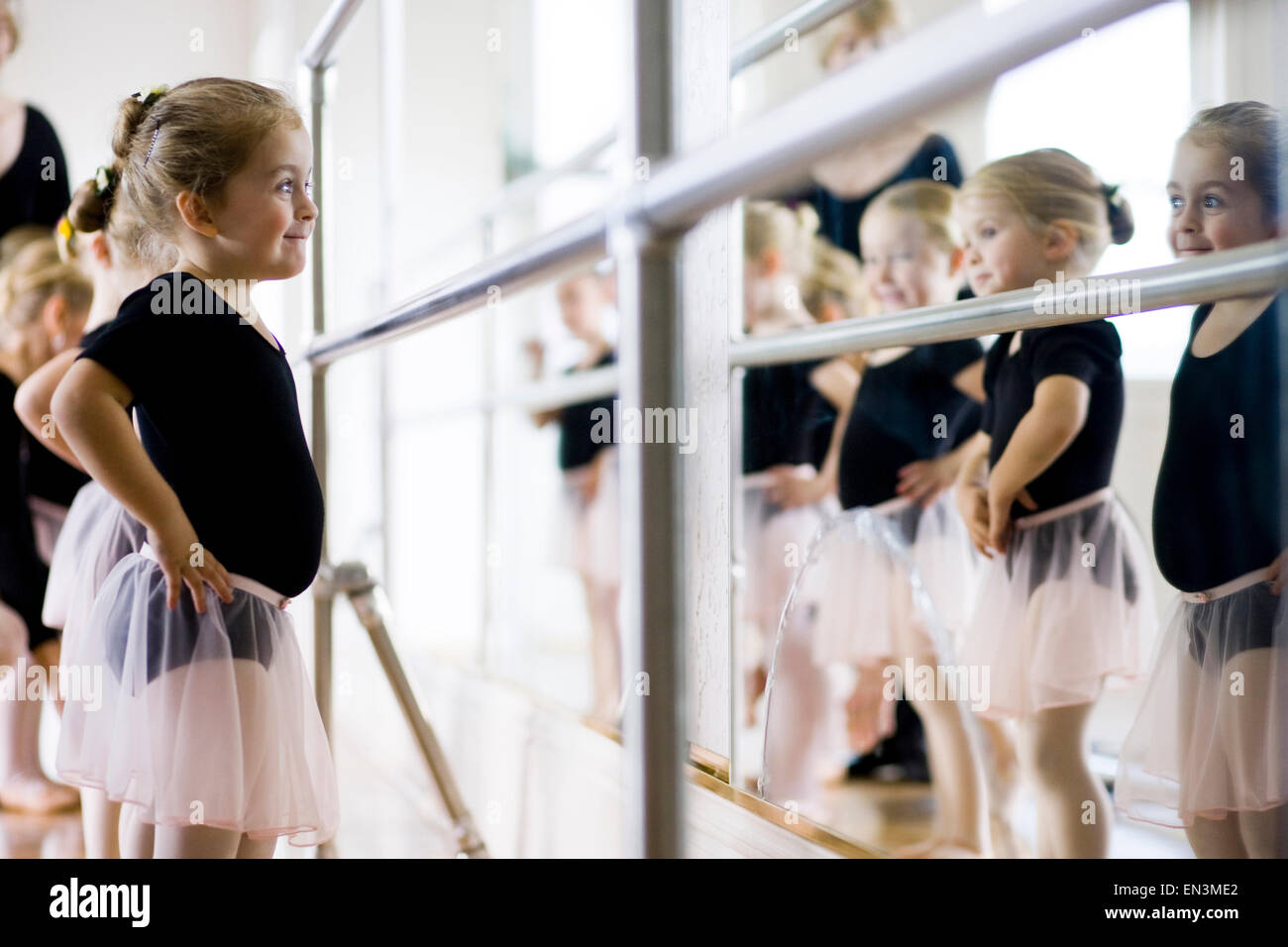 Mature woman teaching girls (12-13,14-15,16-17) ballet in studio Stock Photo