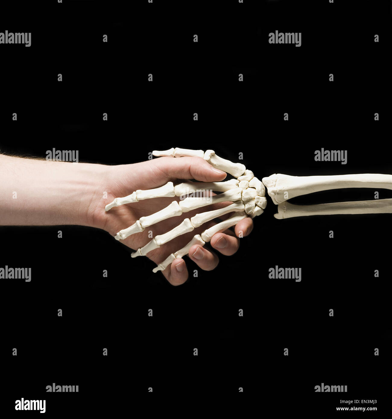 Businessman shaking hands with skeleton Stock Photo