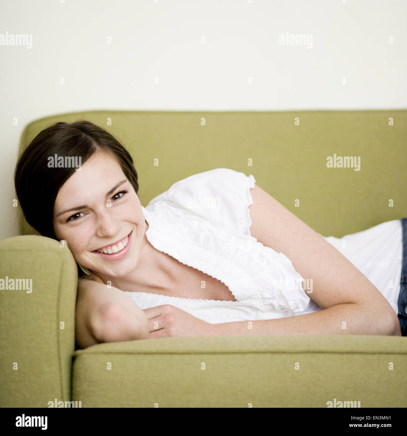 woman lying on a couch Stock Photo