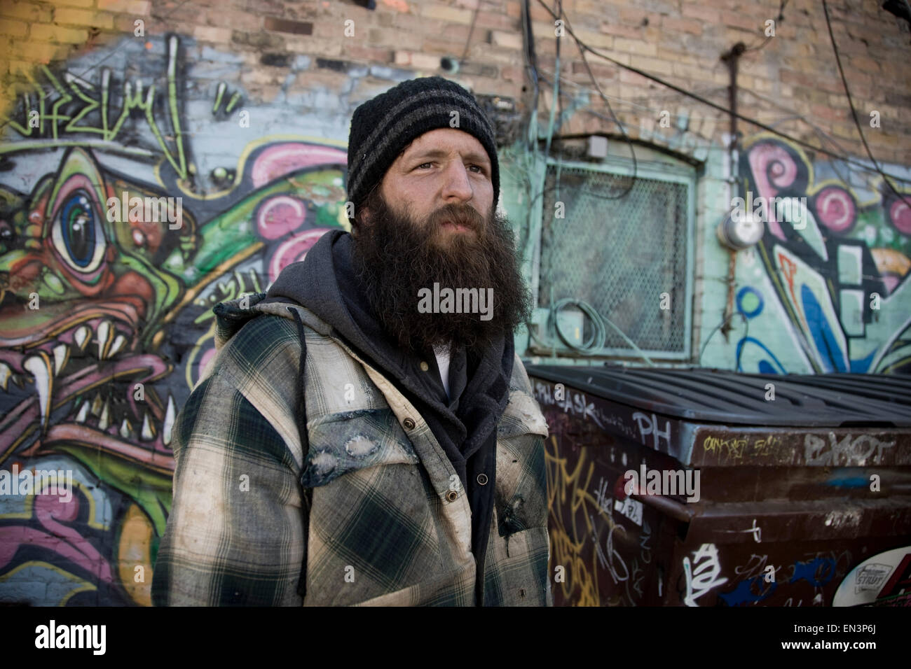 USA, Utah, Salt Lake City, homeless man near graffiti wall Stock Photo