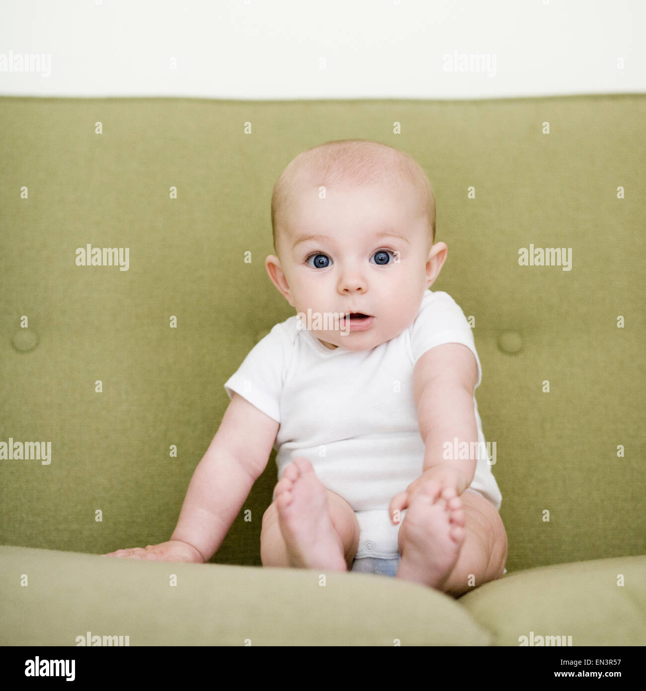baby girl on a sofa Stock Photo
