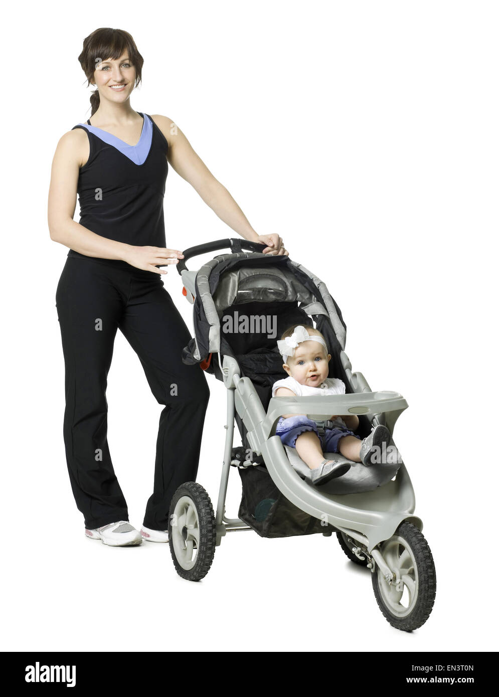 woman pushing her baby in a stroller Stock Photo