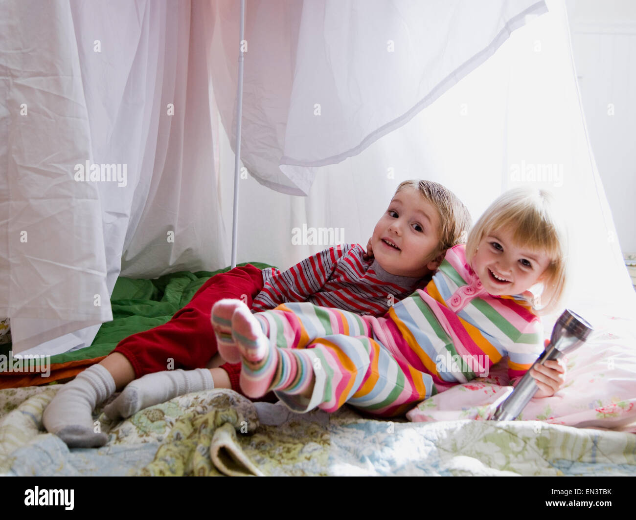 brother and sister in a makeshift fort Stock Photo