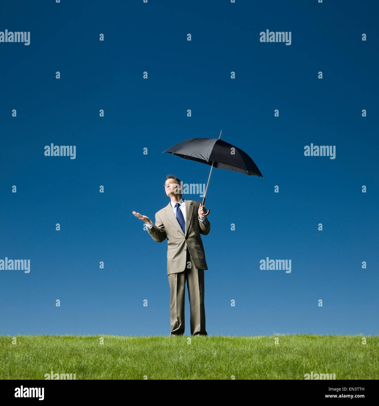 man holding an umbrella checking for rain Stock Photo