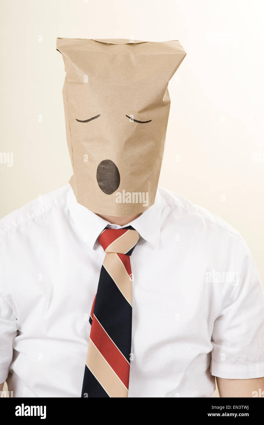 businessman with a brown paper bag over his head Stock Photo