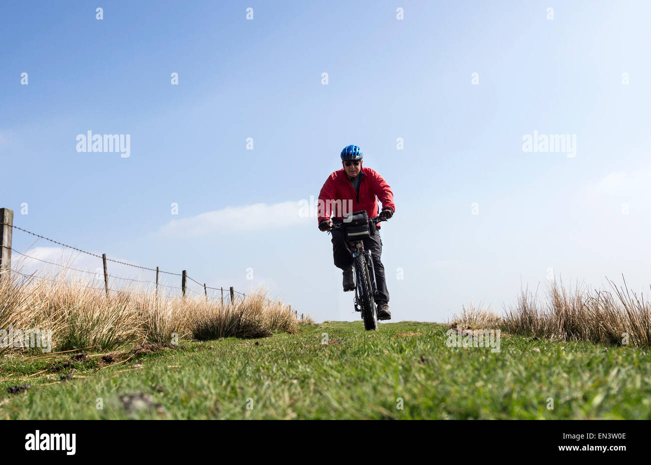 Middle Aged Mountain Biker on Grassy Bridleway Teesdale County Durham UK Stock Photo