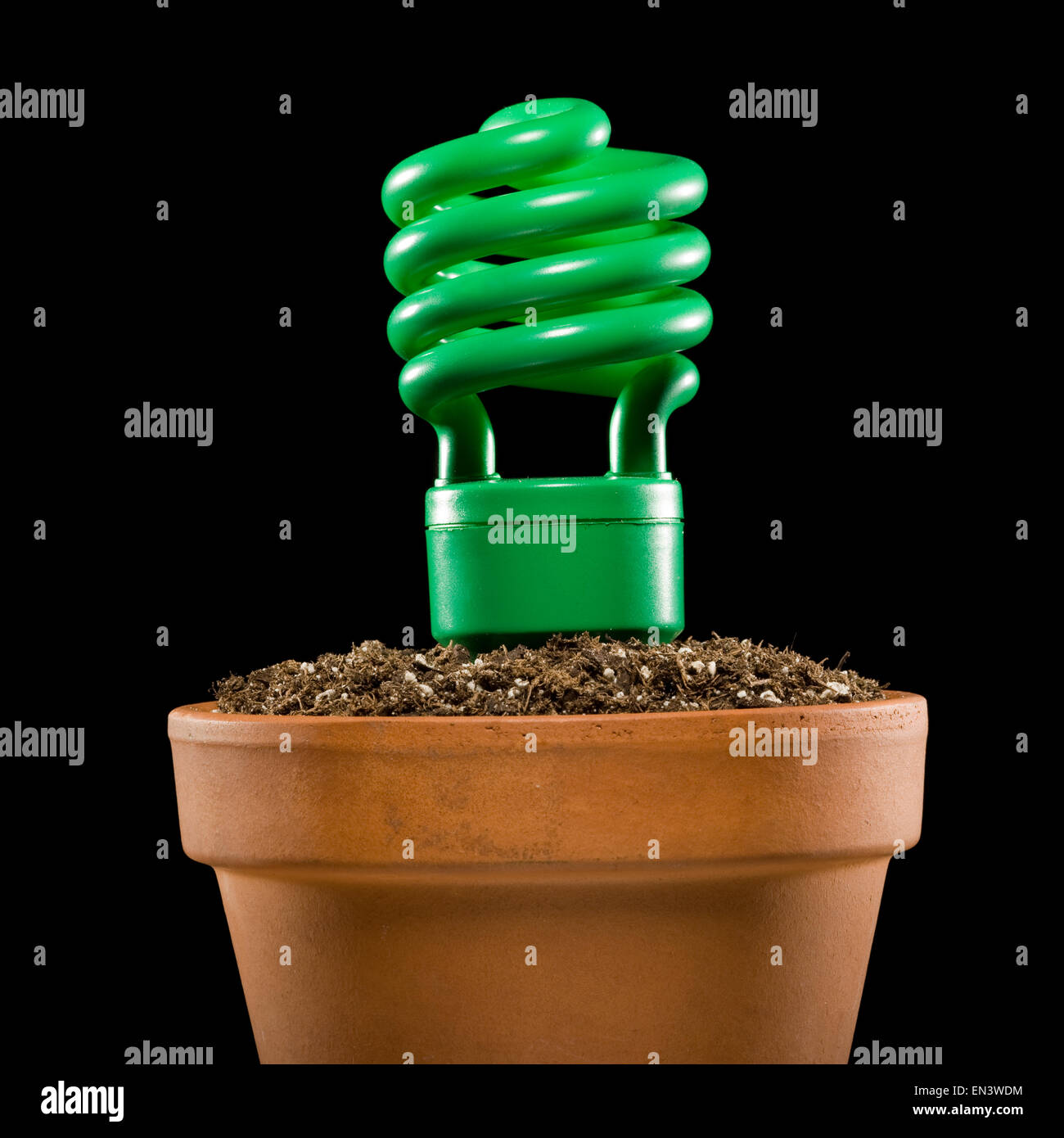 light bulb planted in a pot of soil Stock Photo