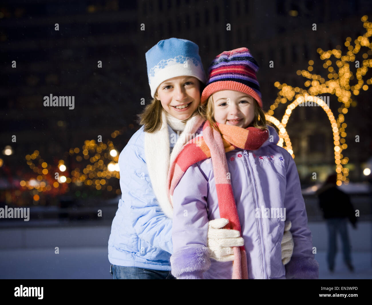 Two girls outdoors in winter smiling Stock Photo - Alamy