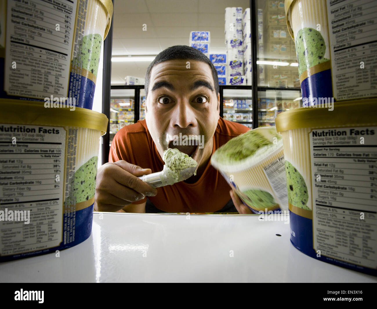 Man eating ice cream at grocery store Stock Photo
