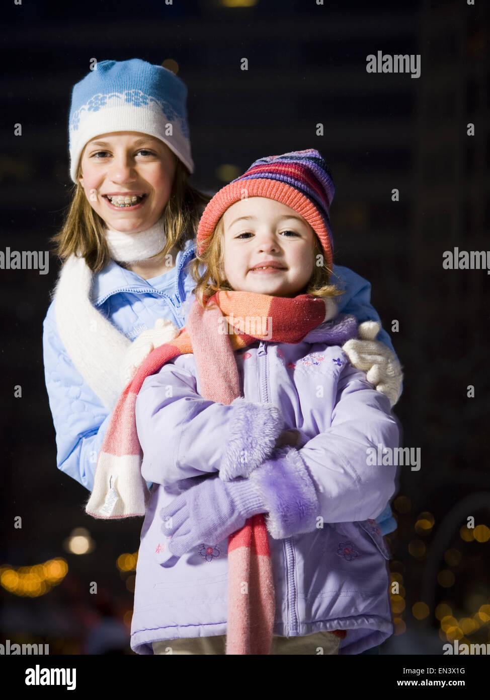 Two girls outdoors in winter smiling Stock Photo