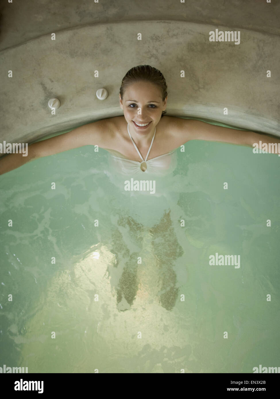 Woman in hot tub smiling Stock Photo