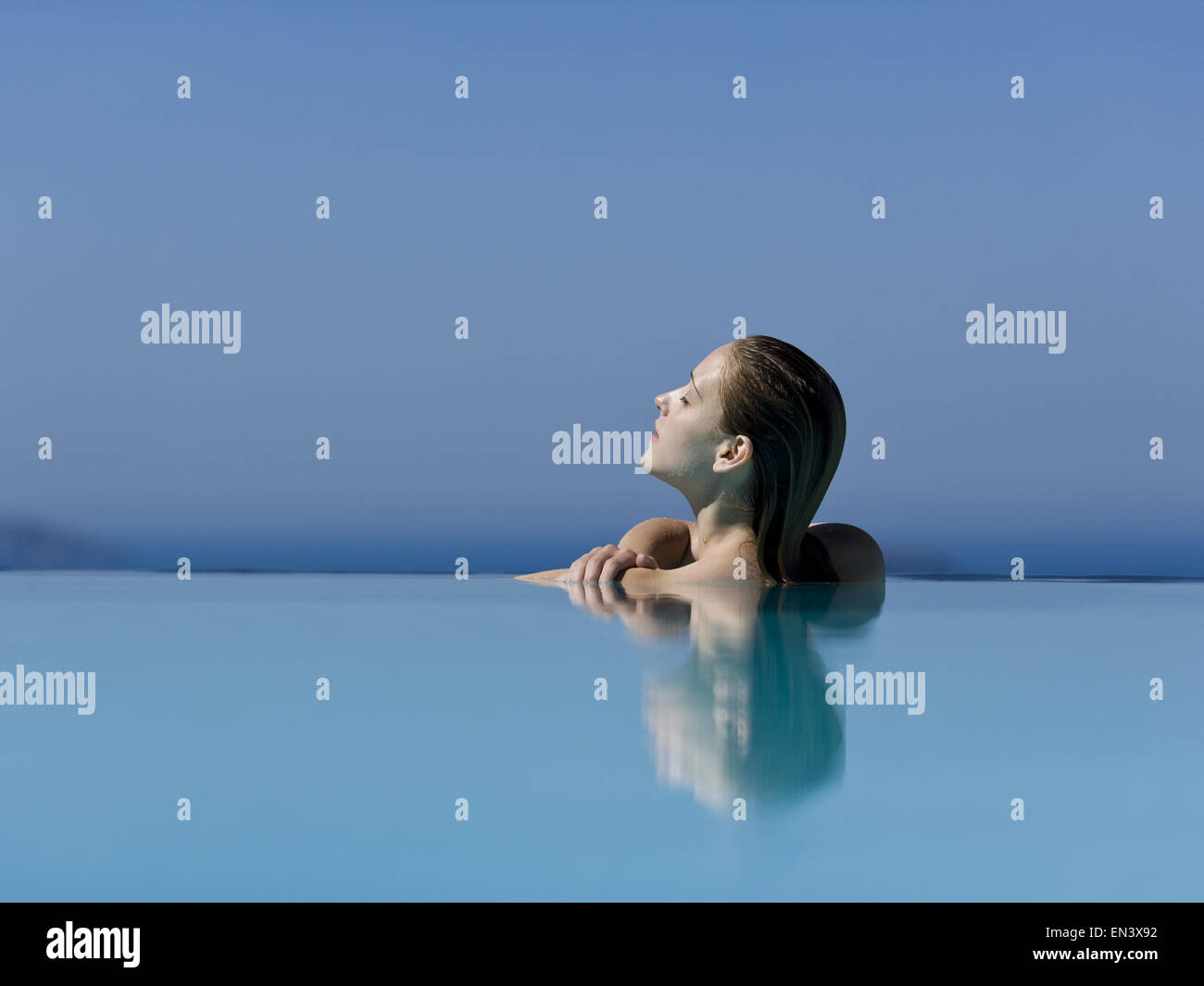 Profile of woman in pool with eyes closed Stock Photo