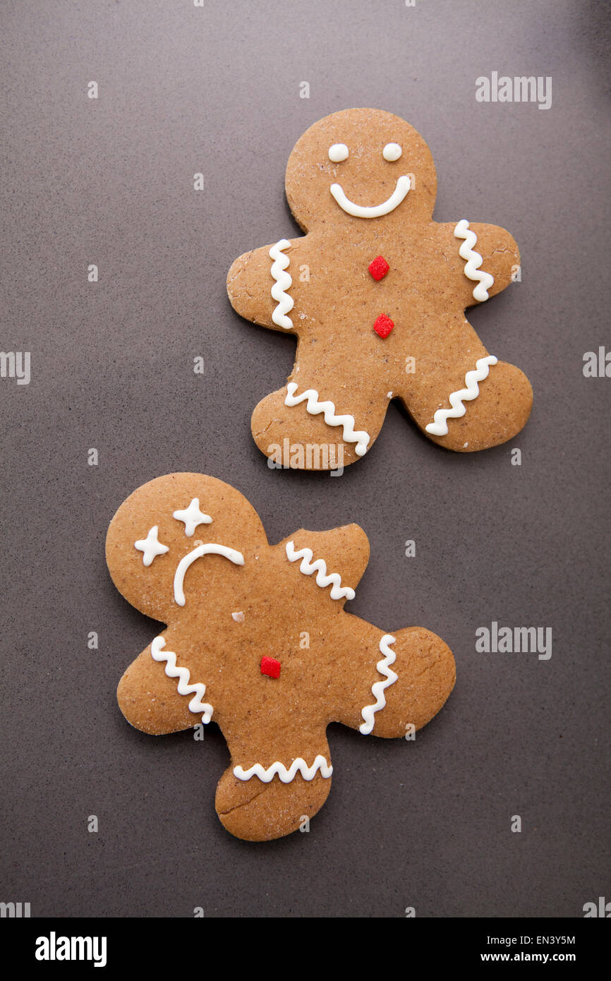 Two gingerbread men on grey background Stock Photo