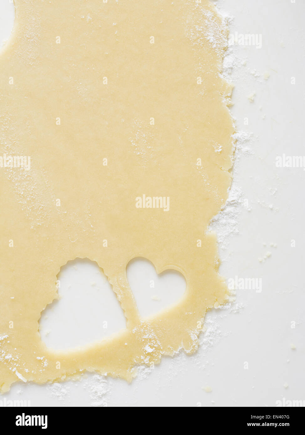 Detailed view of dough with heart cookie cutter Stock Photo