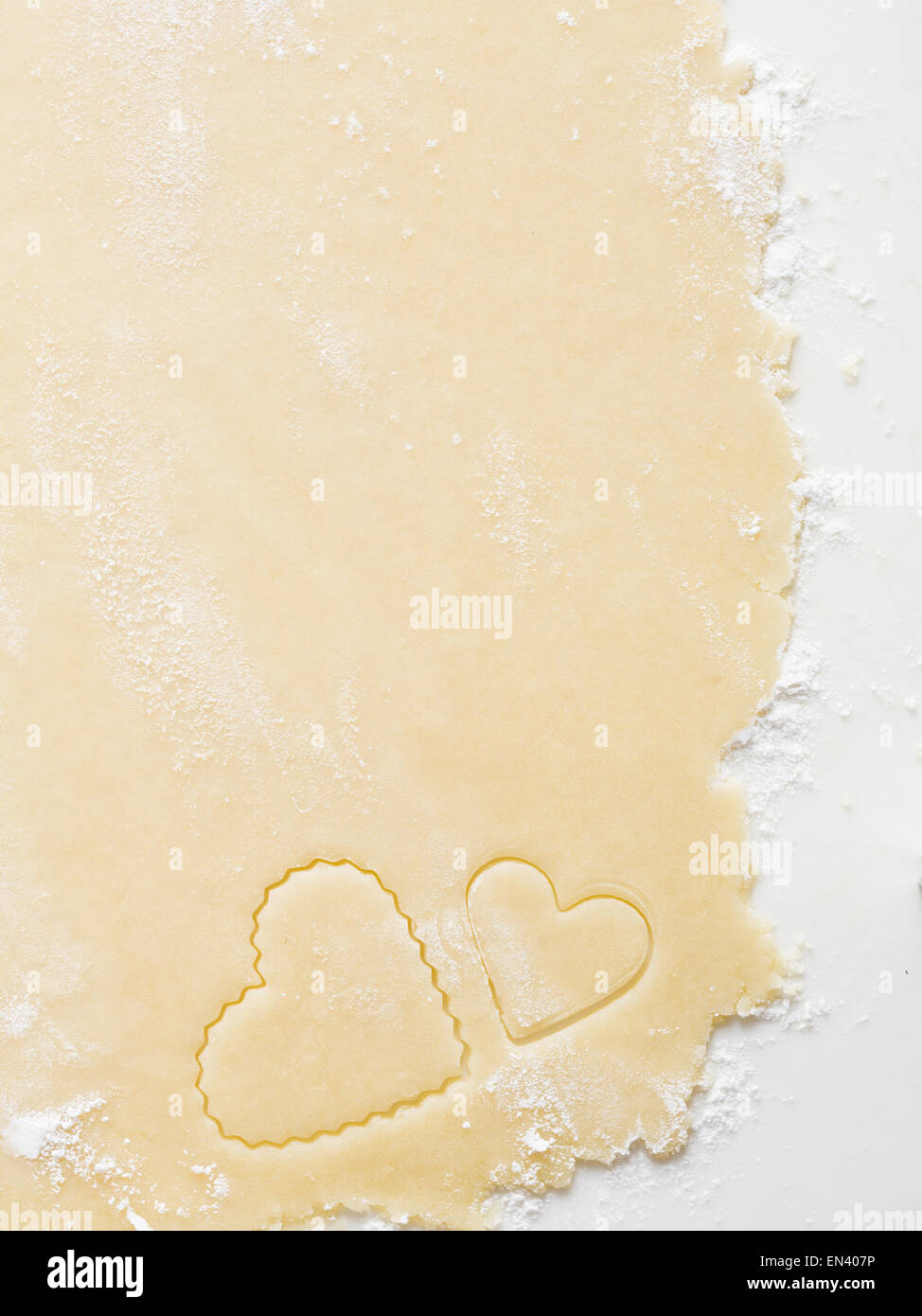 Detailed view of dough with heart cookie cutter Stock Photo