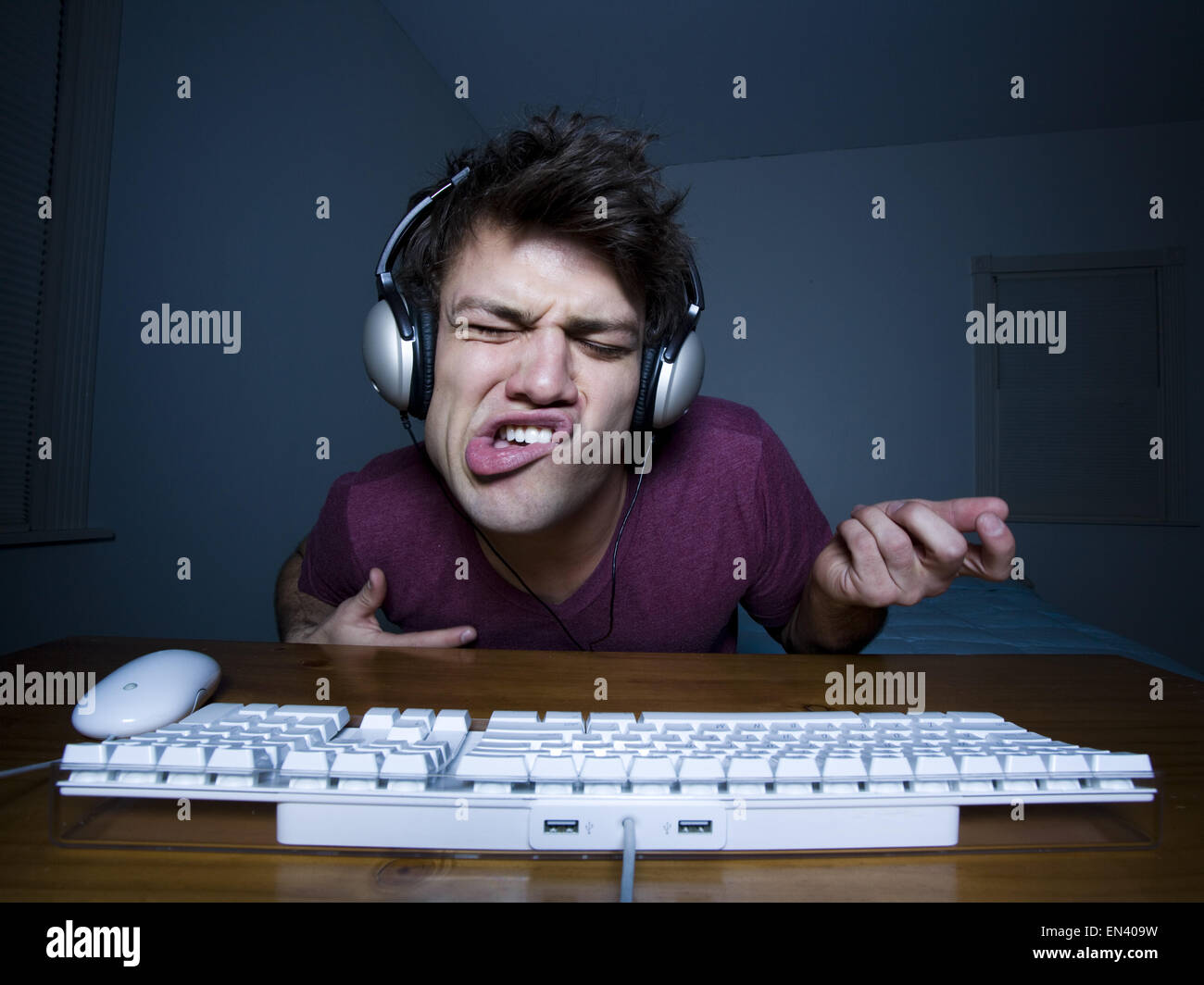 Man with keyboard and headphones playing air guitar Stock Photo Alamy