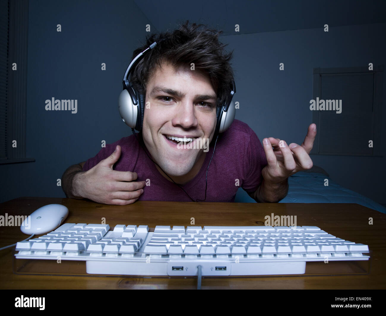 Man with keyboard and headphones playing air guitar Stock Photo Alamy