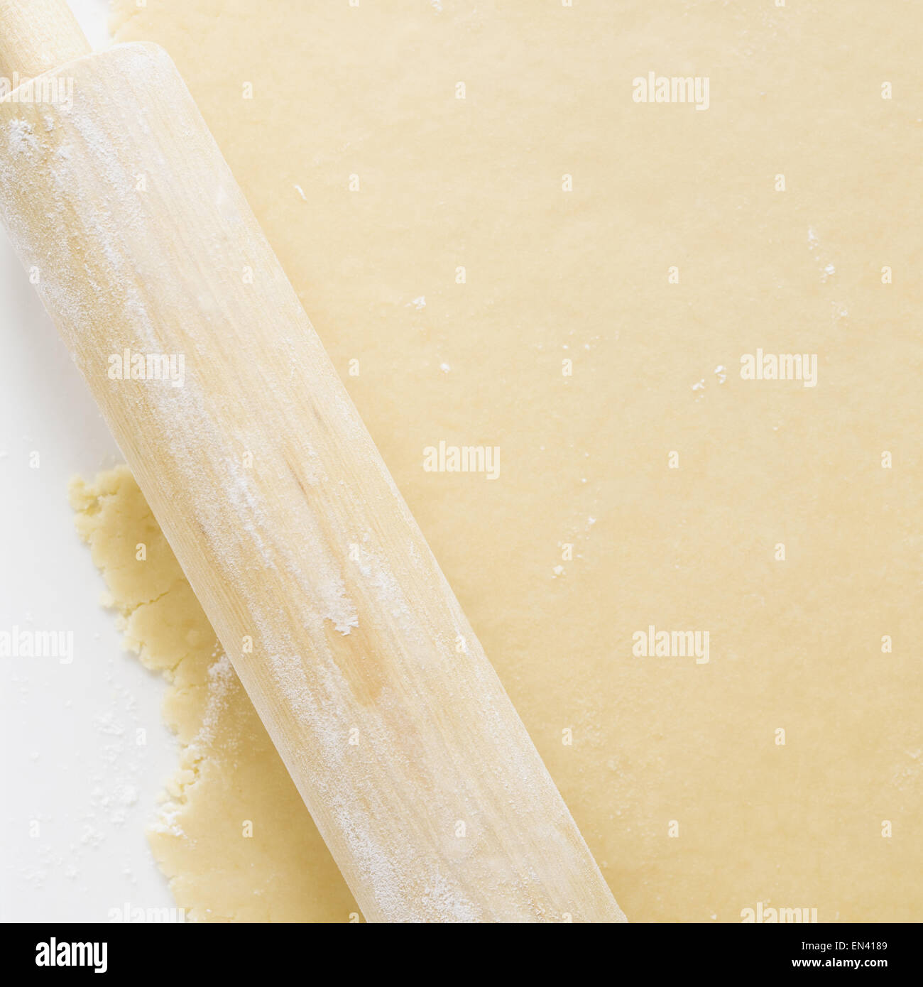Detailed view of dough with rolling pin Stock Photo