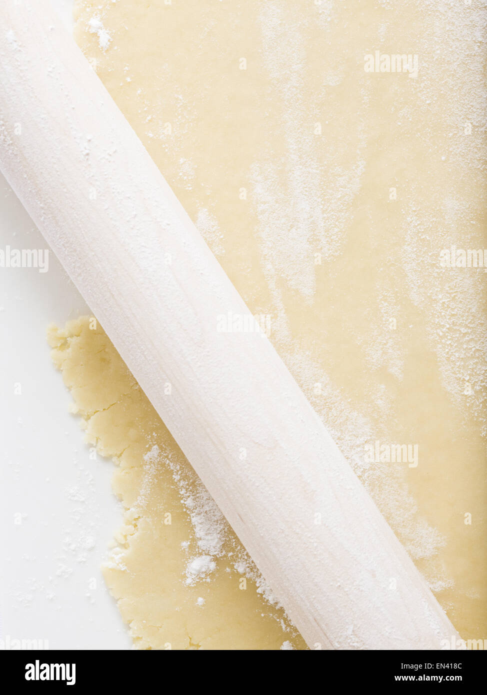 Detailed view of dough with rolling pin Stock Photo