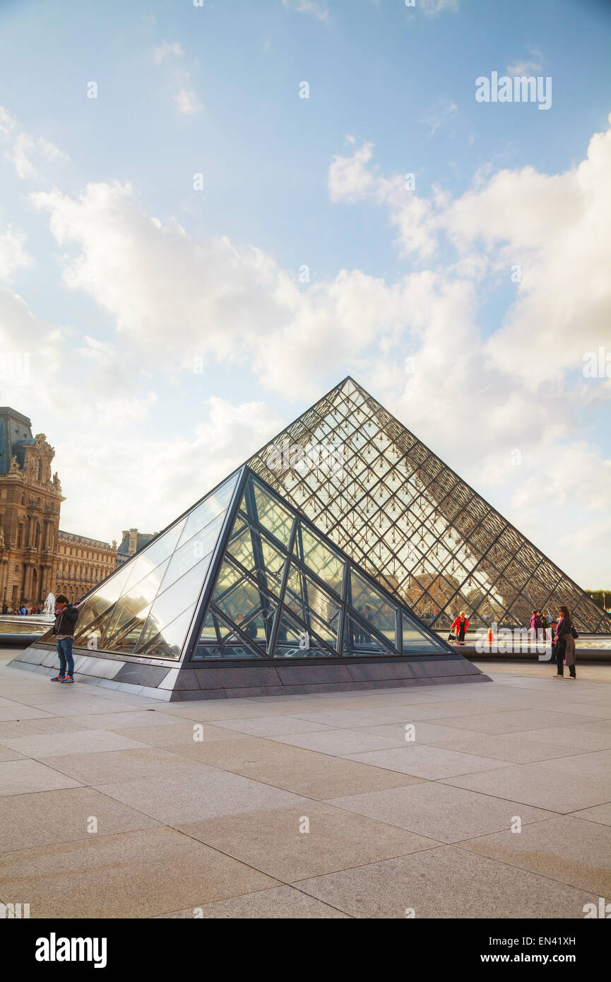 PARIS - OCTOBER 9: The Louvre Pyramid on October 9, 2014 in Paris, France. It serves as the main entrance to the Louvre Museum. Stock Photo