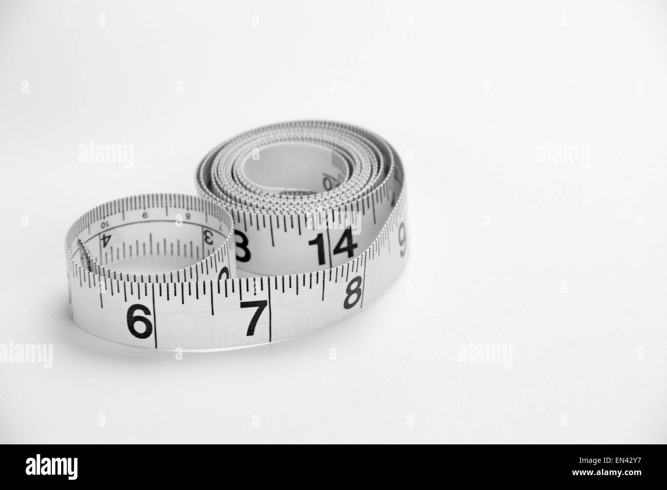 A tape measure on a white background Stock Photo