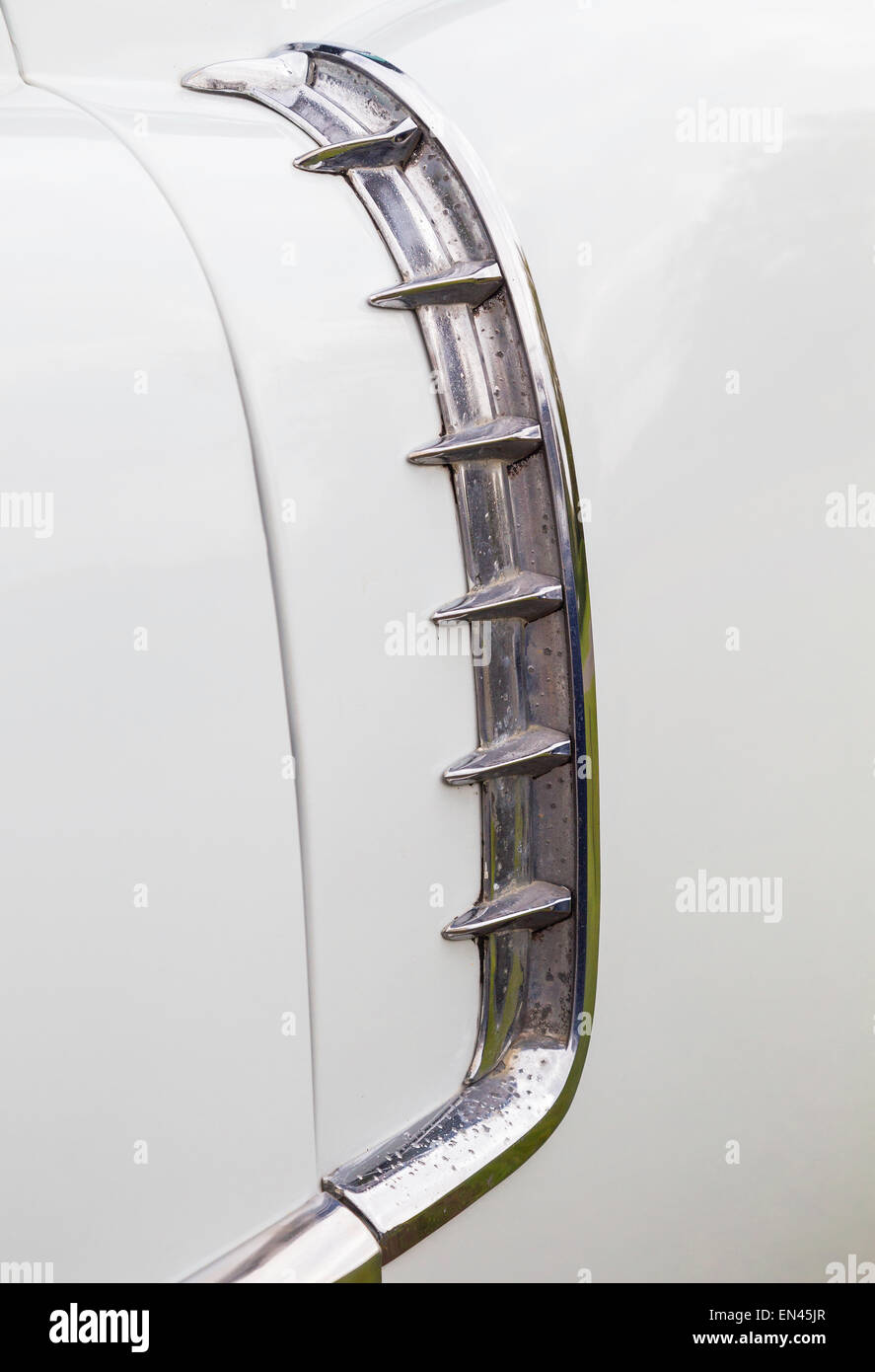 A detail of the left side of a white 1956 Cadillac Coupe De Ville. Stock Photo