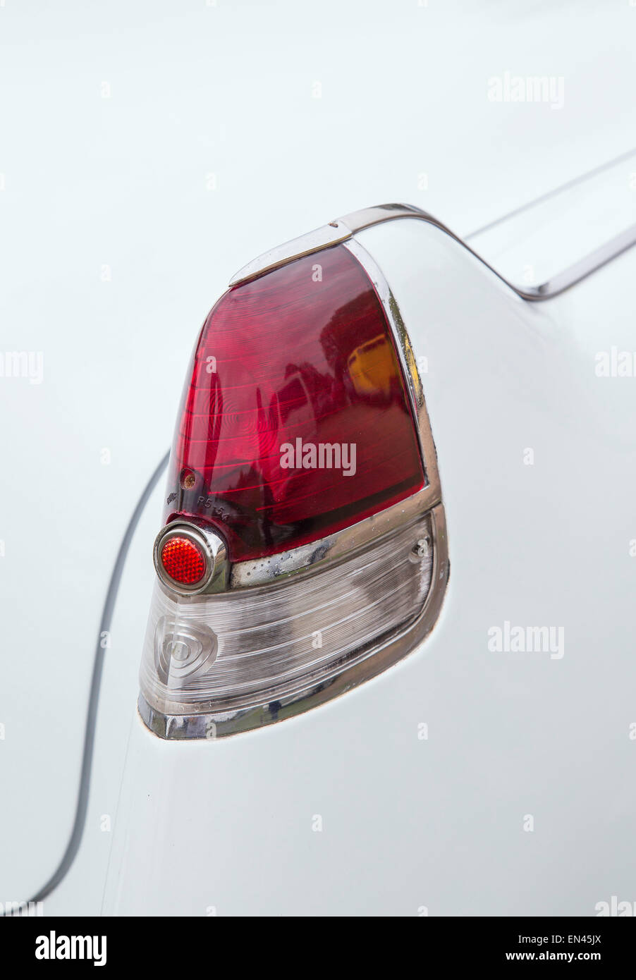 A detail of the tail light of a white 1956 Cadillac Coupe De Ville. Stock Photo