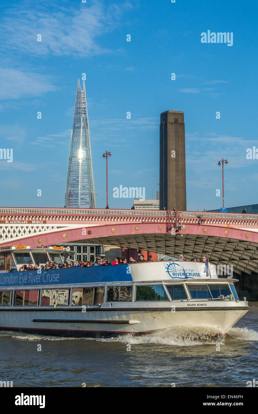 Blackfriars Bridge over the River Thames and a 'London Eye River Cruise' boat, with The Shard in the background. Stock Photo