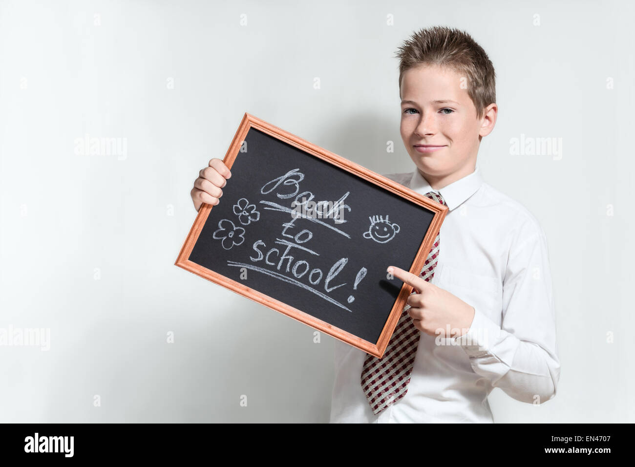 Smiling schoolboy with chalkboard Stock Photo