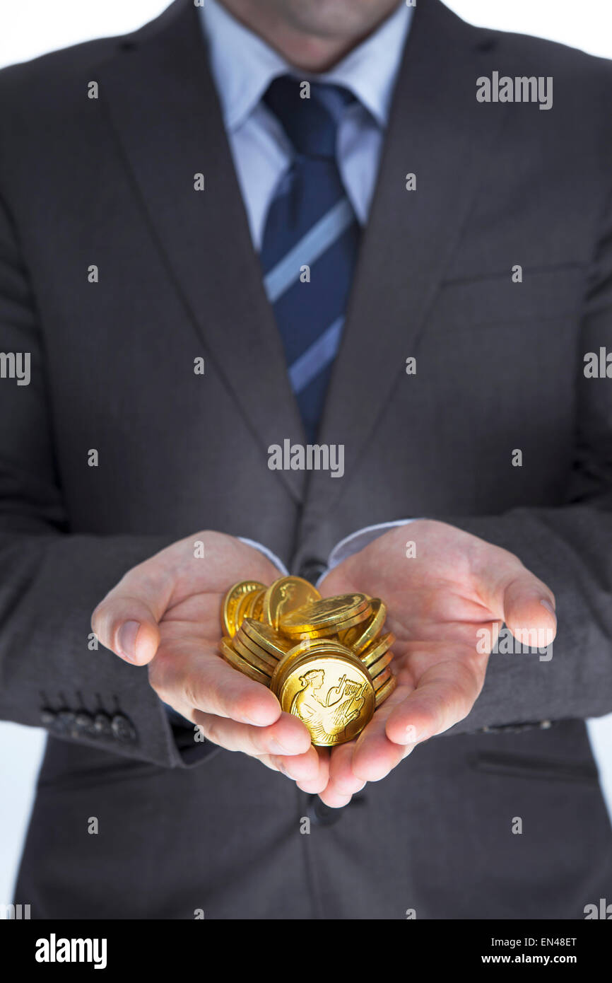 Business man holding golds in hands. Finance voncept Stock Photo