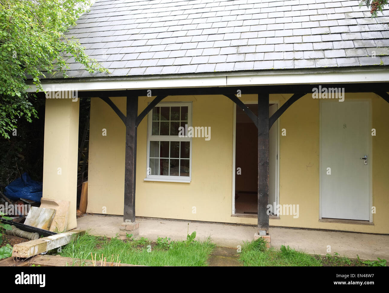 Open door to a bed and breakfast extension behind a village pub in