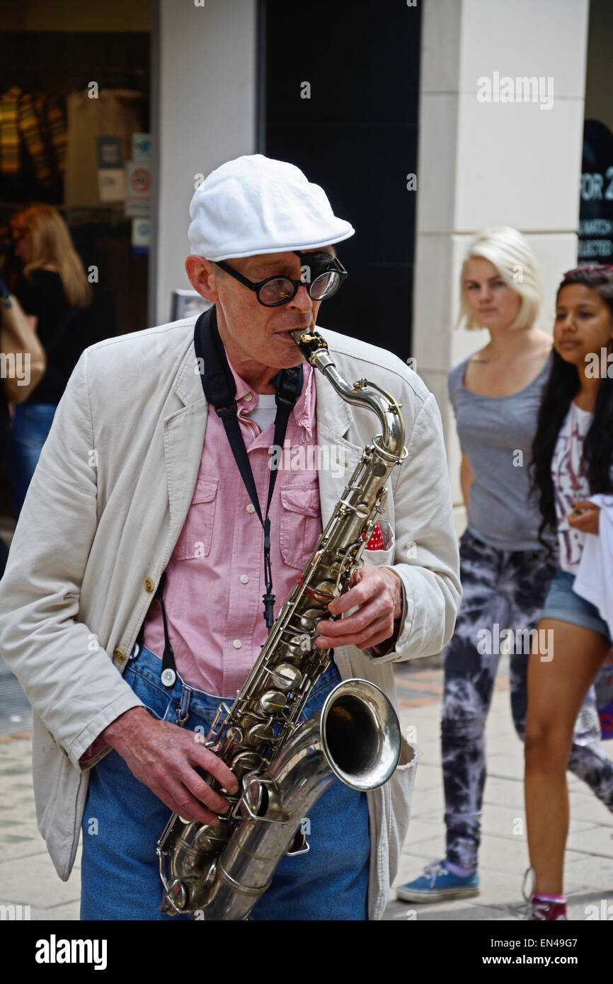 Man playing saxophone in street Stock Photo